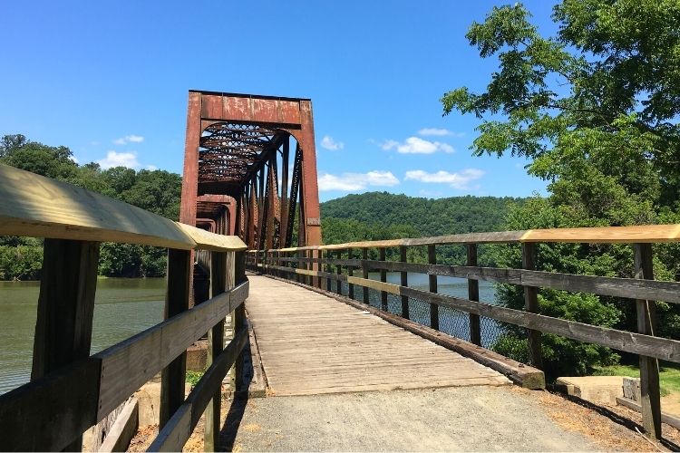 Hiking on the New River Trail in Virginia. Try one of these 8 state parks for fall travel.