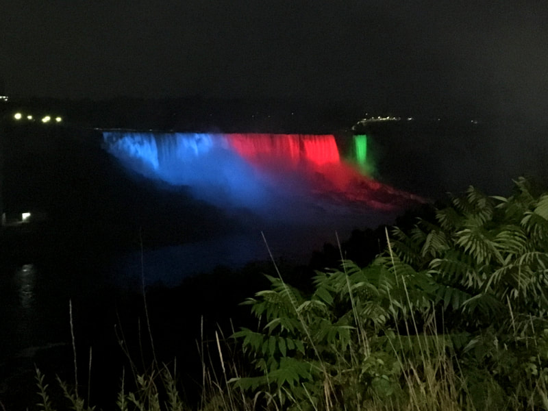 Niagara falls lit up at night