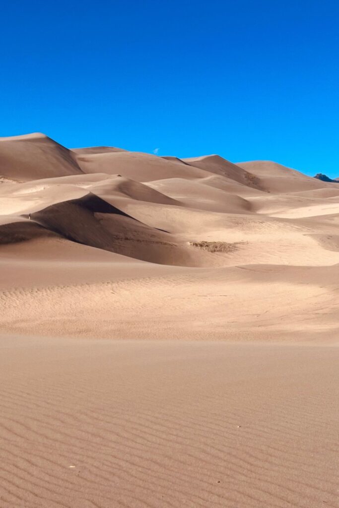 view of giant sand dunes - What to Expect When Visiting Great Sand Dunes National Park & Preserve