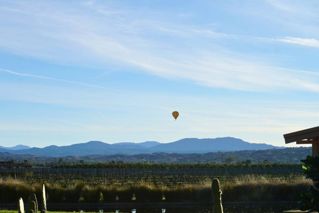 View of a hot air balloon in front of the mountains in Temecula, California